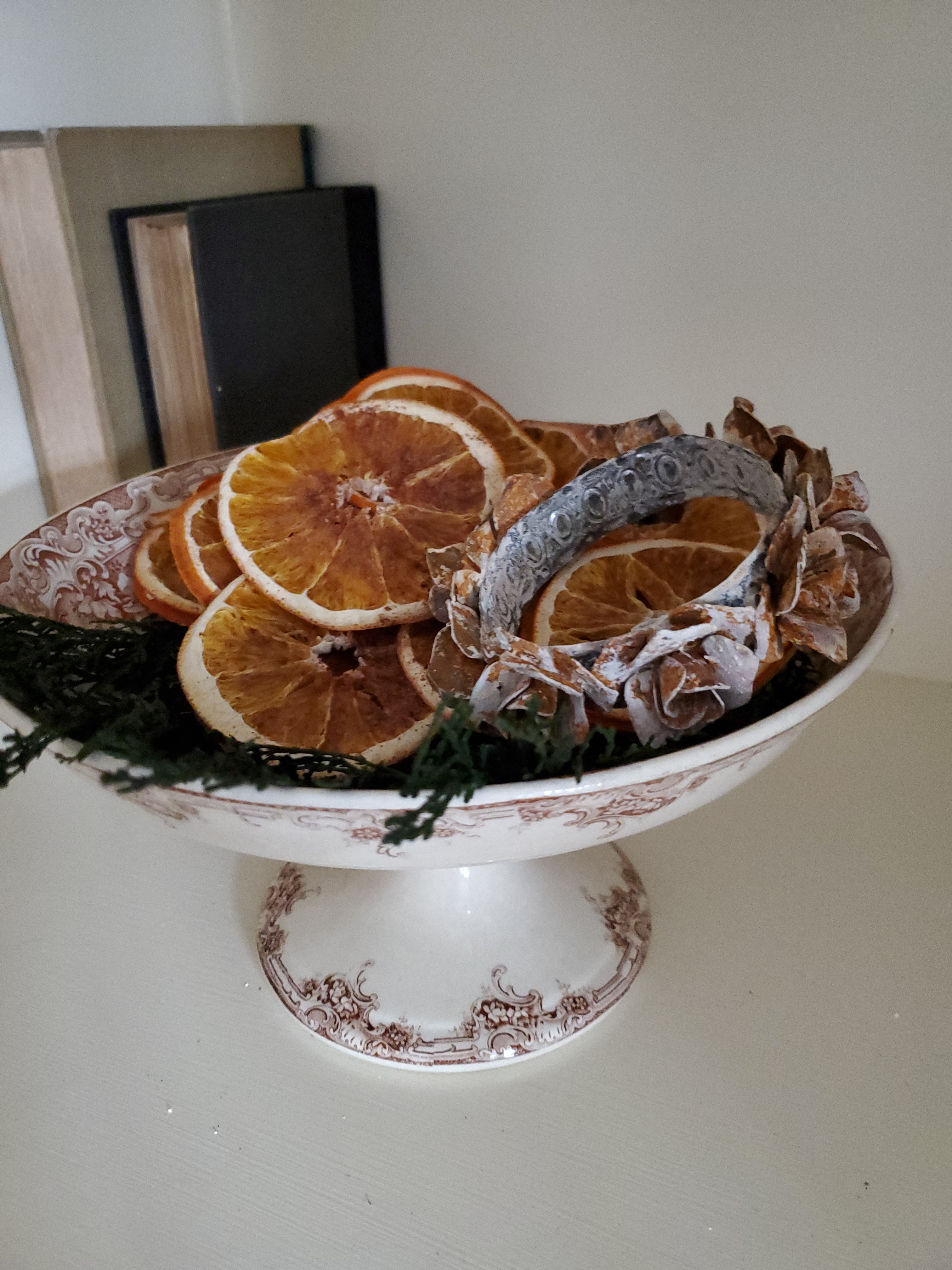 a compote filled with greens and orange slices