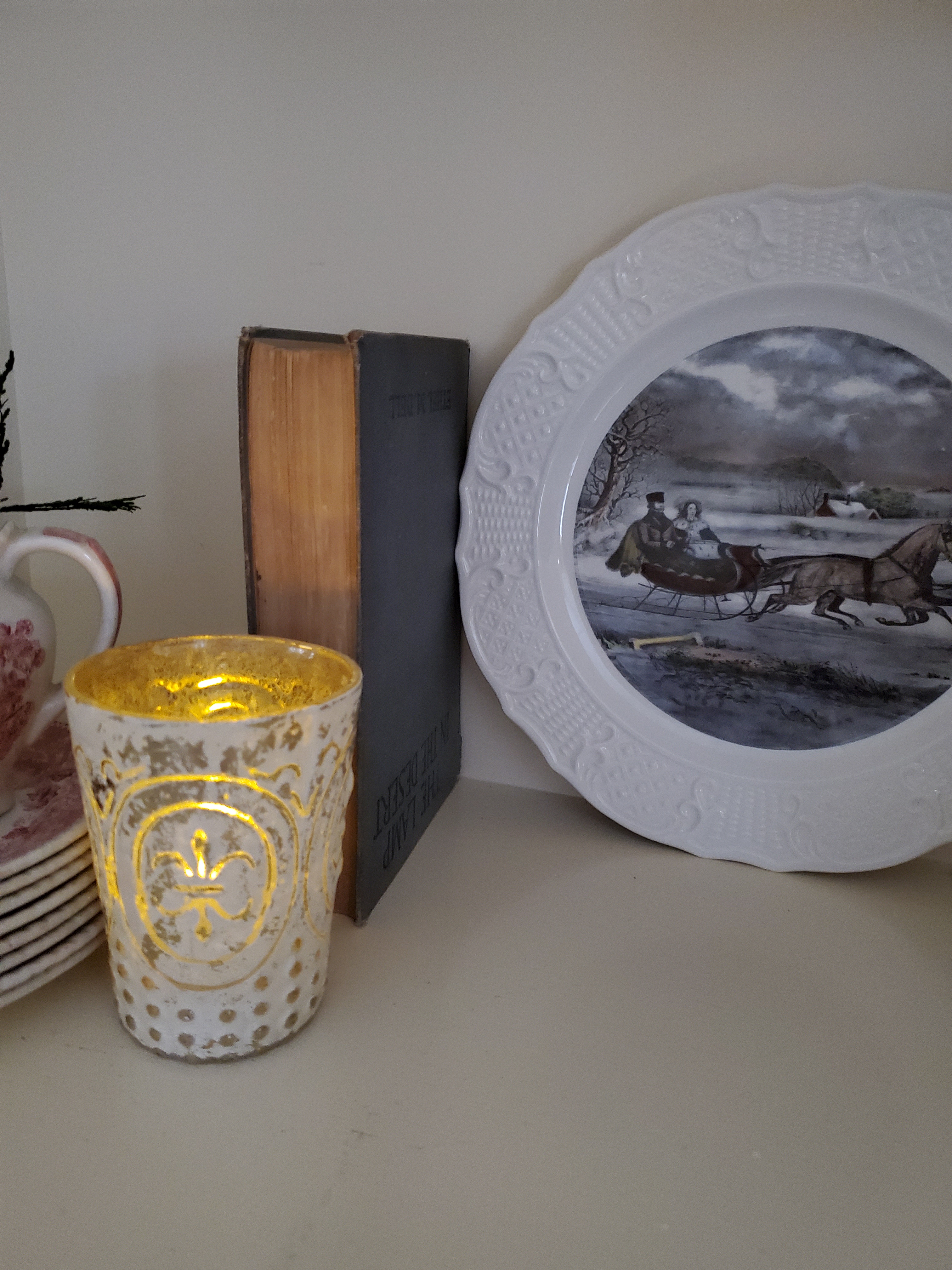 an old book with a dish sharing a winter scene