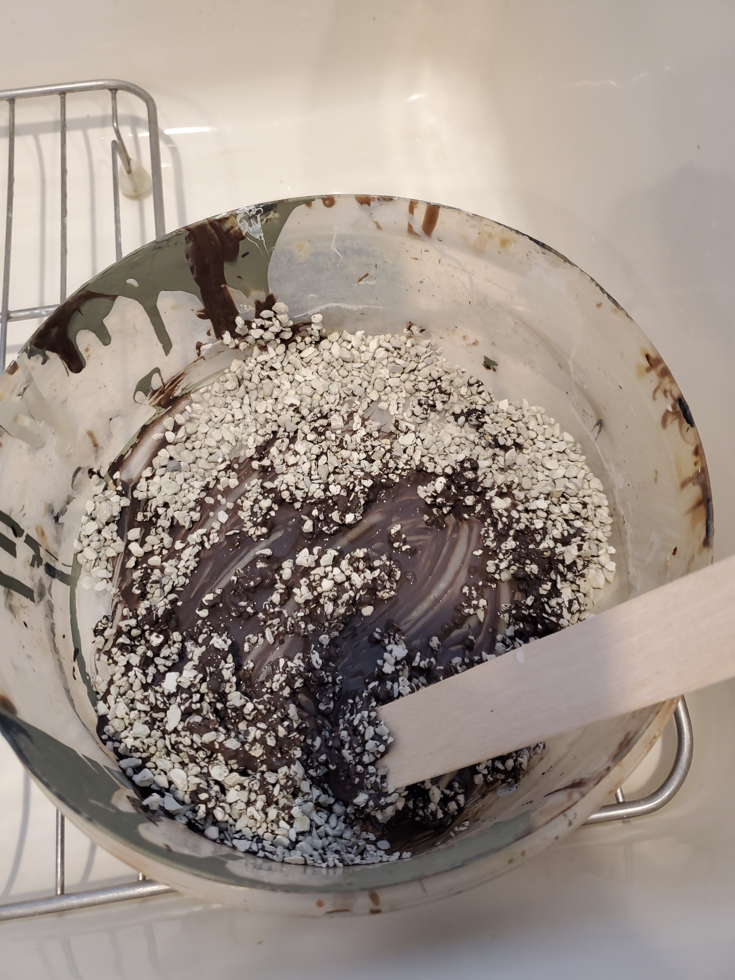 showing the paint, kitty litter and glue combined in a container