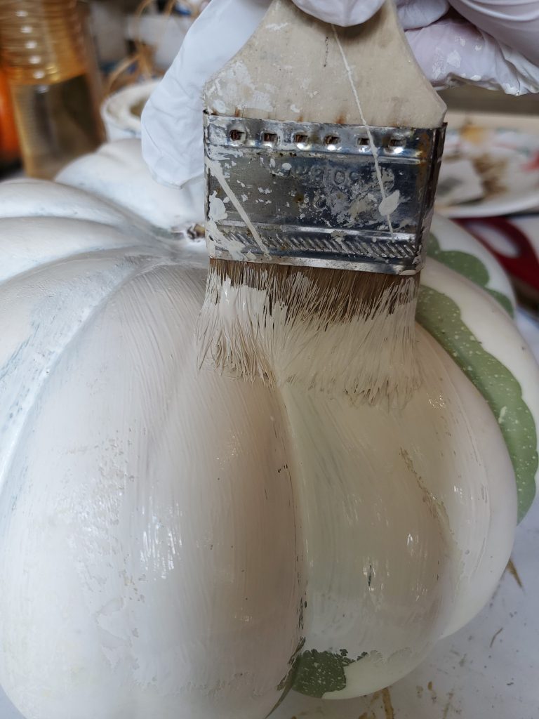 painting the pumpkin with white