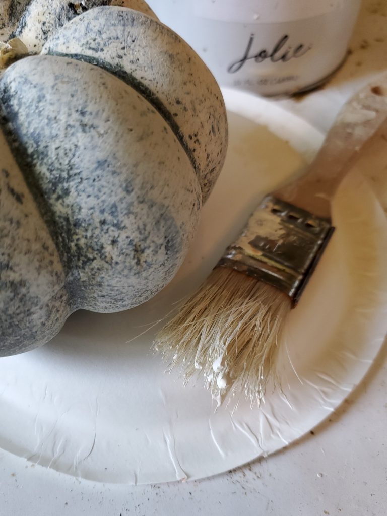 dry brushing the small pumpkin to add to the shelves