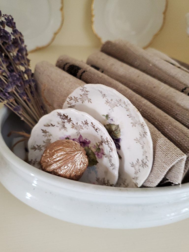 decorating shelves for fall a tureen bottom filled with fabric and a walnut