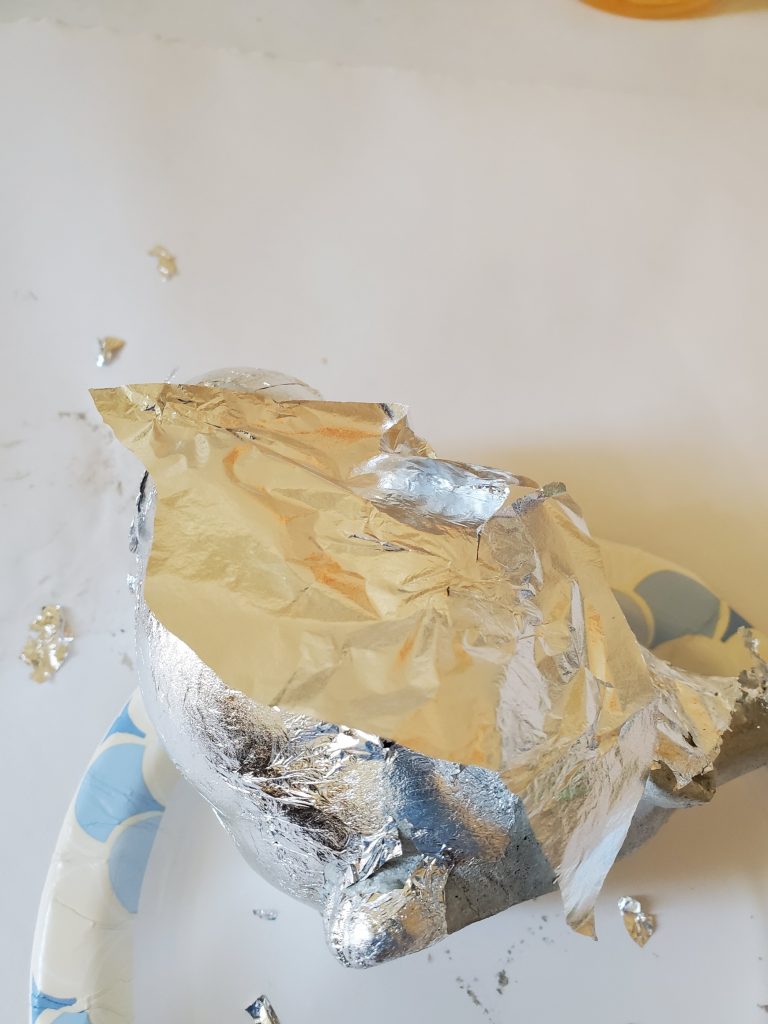 adding a sheet of silver leaf