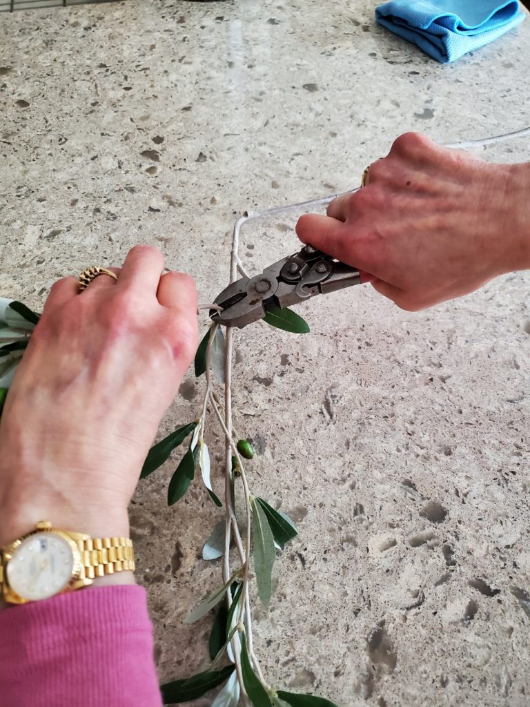 cutting a branch off for the easy wreath