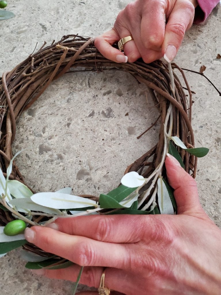 adding the stems to the grapevine wreath