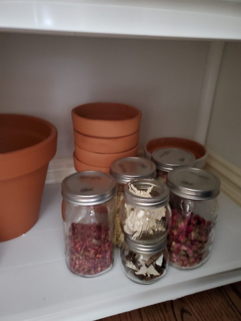 flowerpots and mason jars organized in the closet
