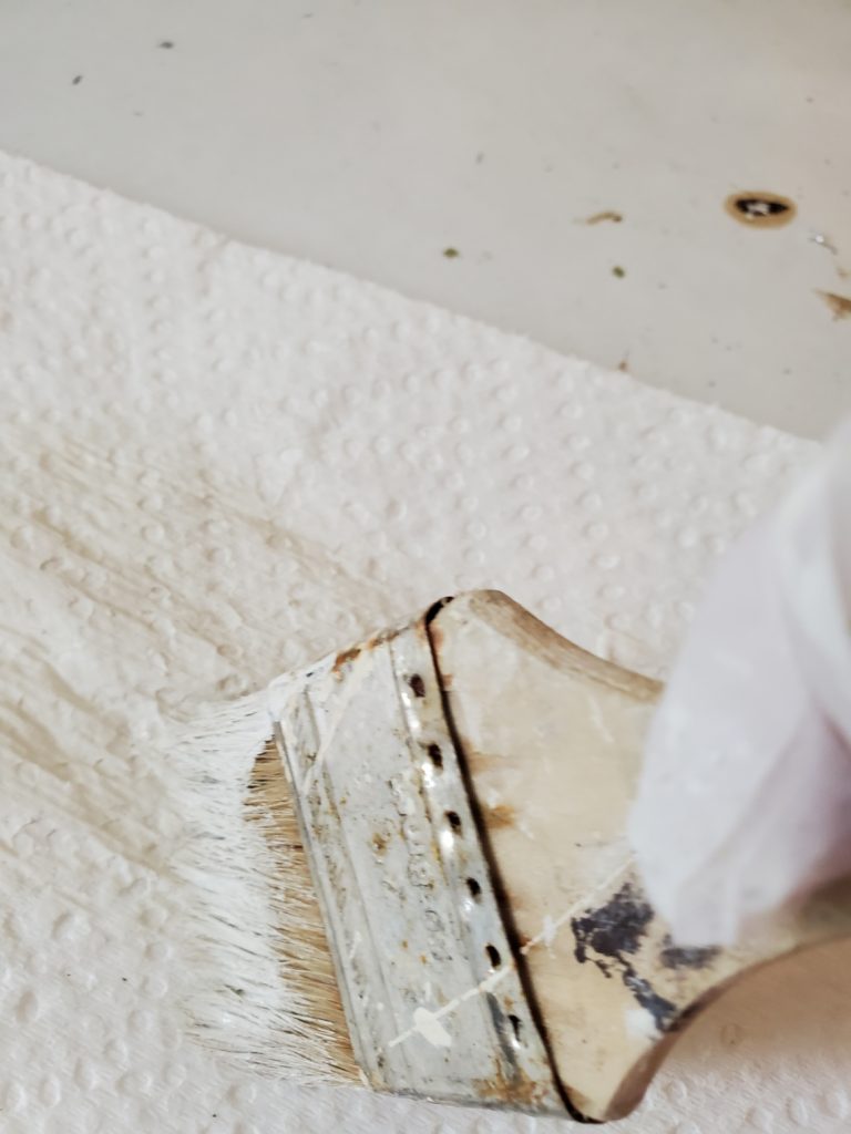 wiping paint off my brush to dry brush