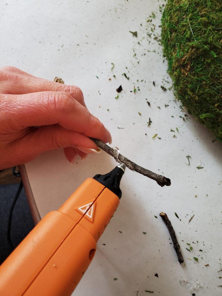 adding hot glue to the stick