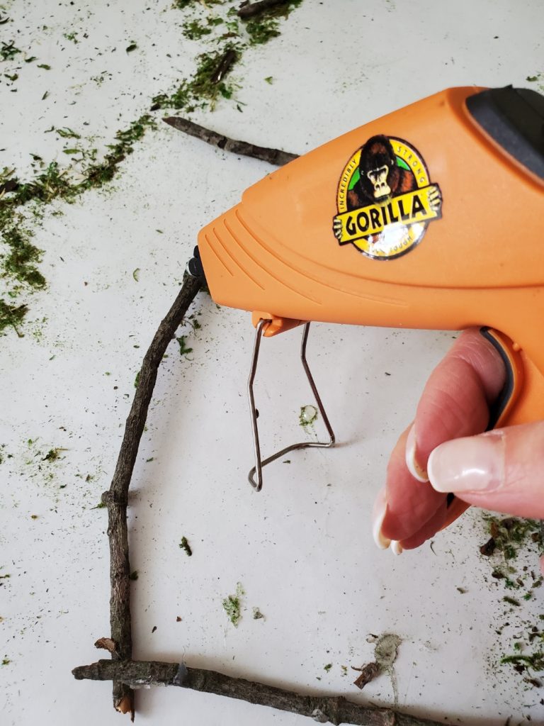 adding hot glue to the sticks
