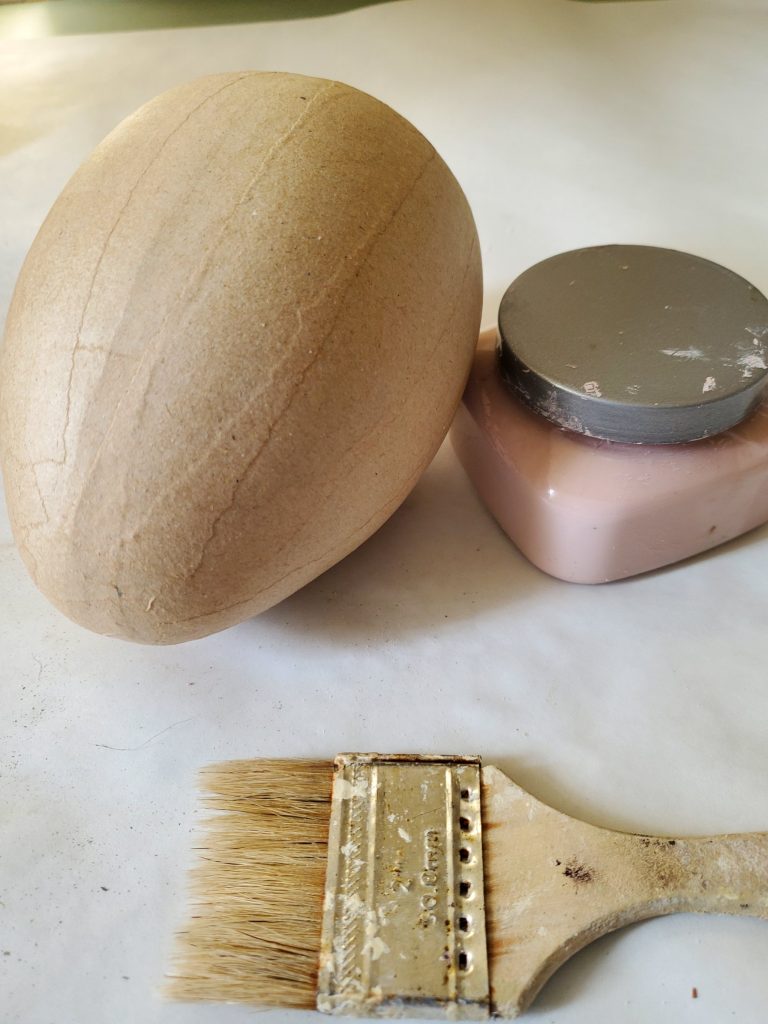 paper Mahe egg with pink paint before I decide to paint it ivory