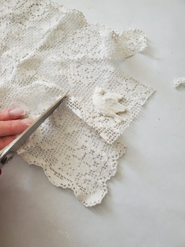 Easter Egg Crafts cutting my lace out for the front of this craft