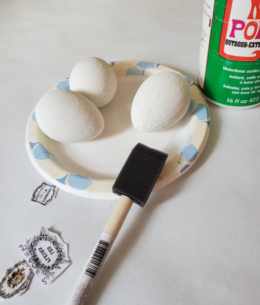 adding my graphics using Mod Podge and a sponge brush