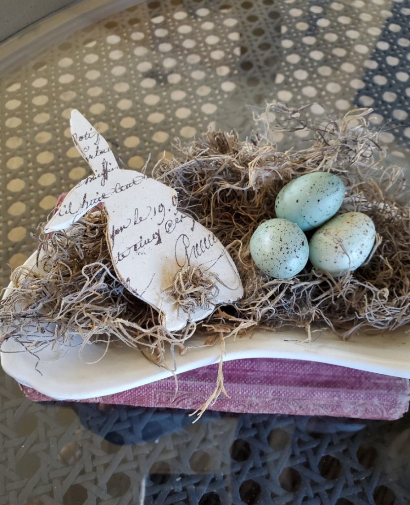 Easter Eggs and Bunny on the coffee table in a small ironstone dish with pink books