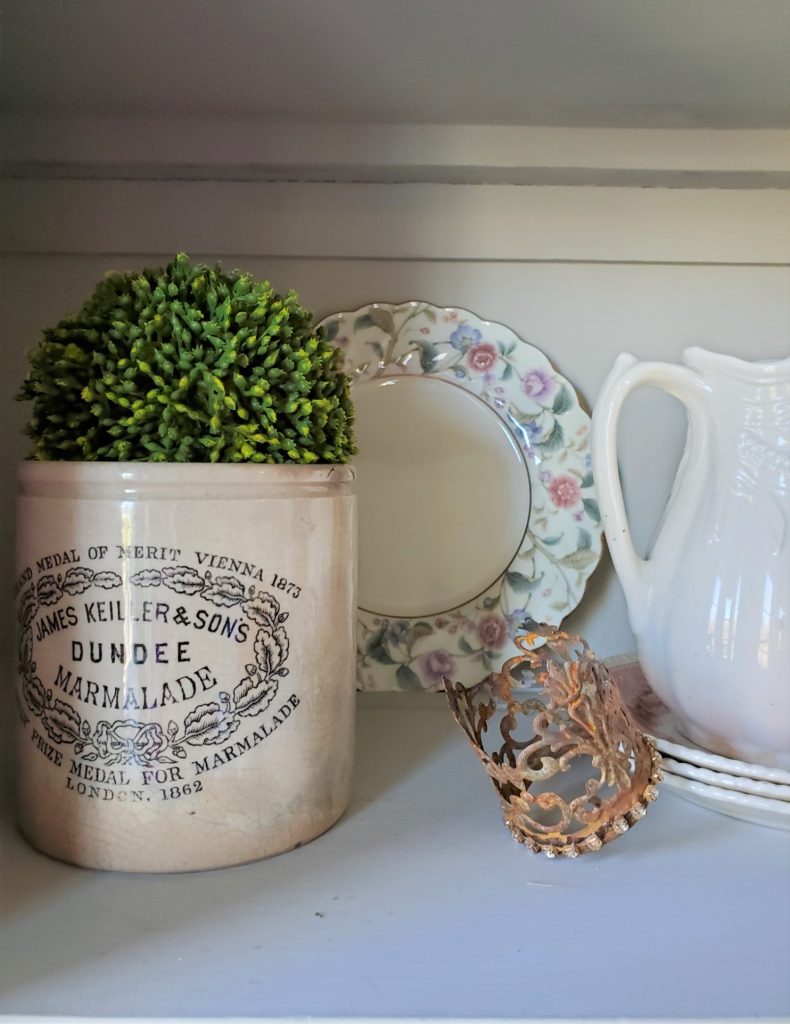 close up of an advertising crock and a small crown