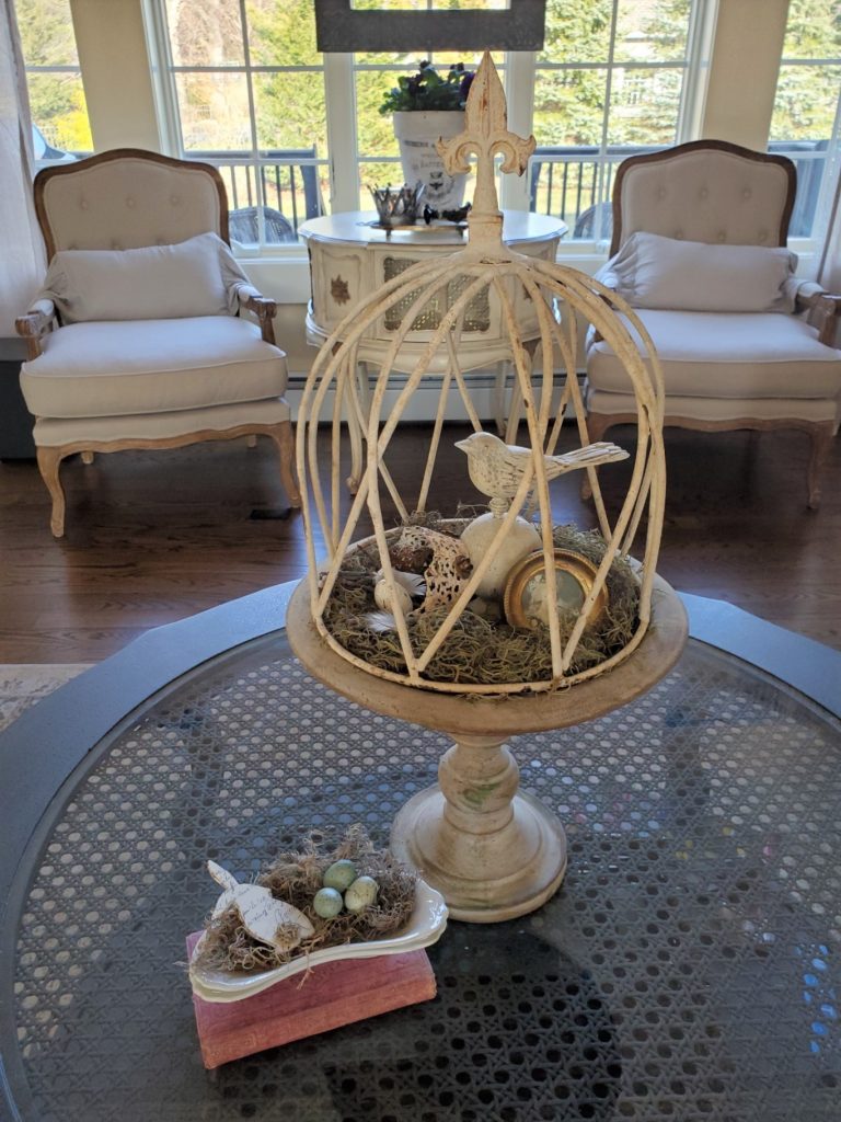 a cloche with a bitd finial and Spanish moss