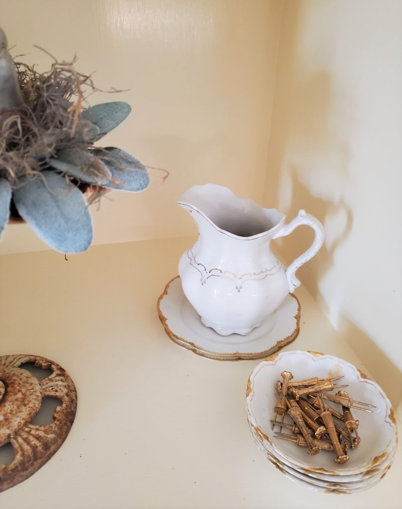 a ironstone pitcher and dishes filled with Florentine corn on the cob holders
