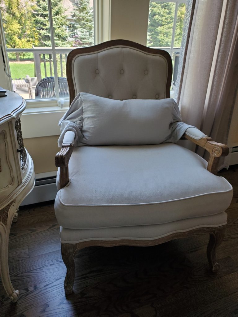 a French chair with a lumbar pillow