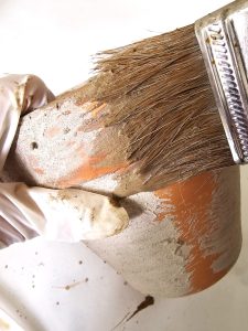 adding-lime-with-a-brush-to-a-big-pot