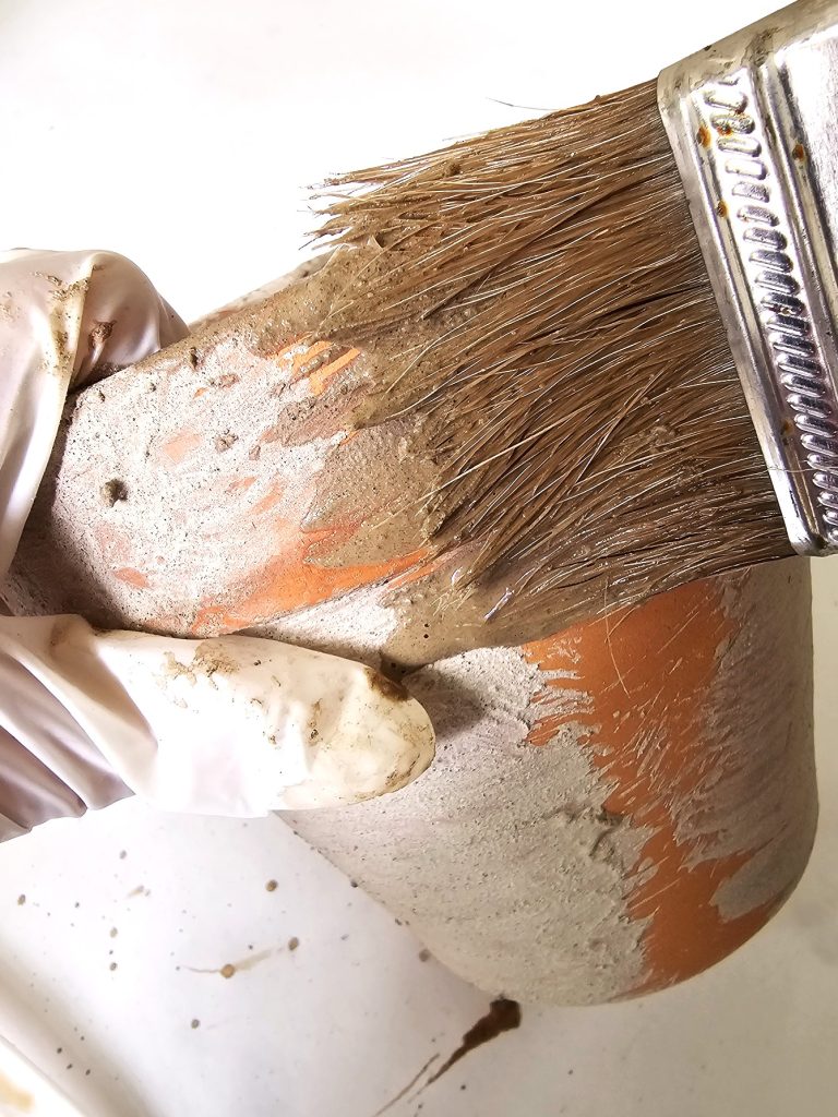 adding-lime-with-a-brush-to-a-big-pot