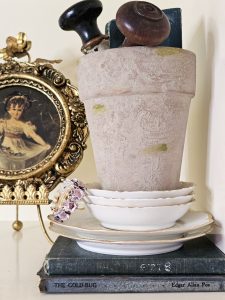 lime-pot-with-old-door-knobs-on-white-dishes-and-books