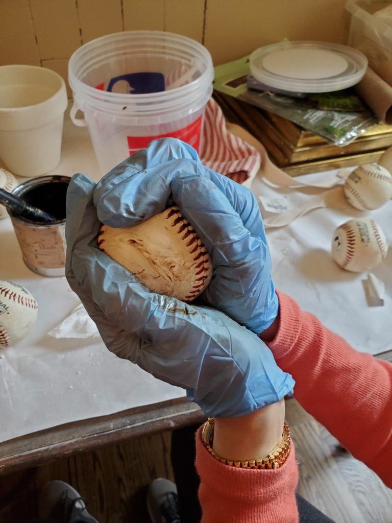 rubbing dark wax on the baseball
