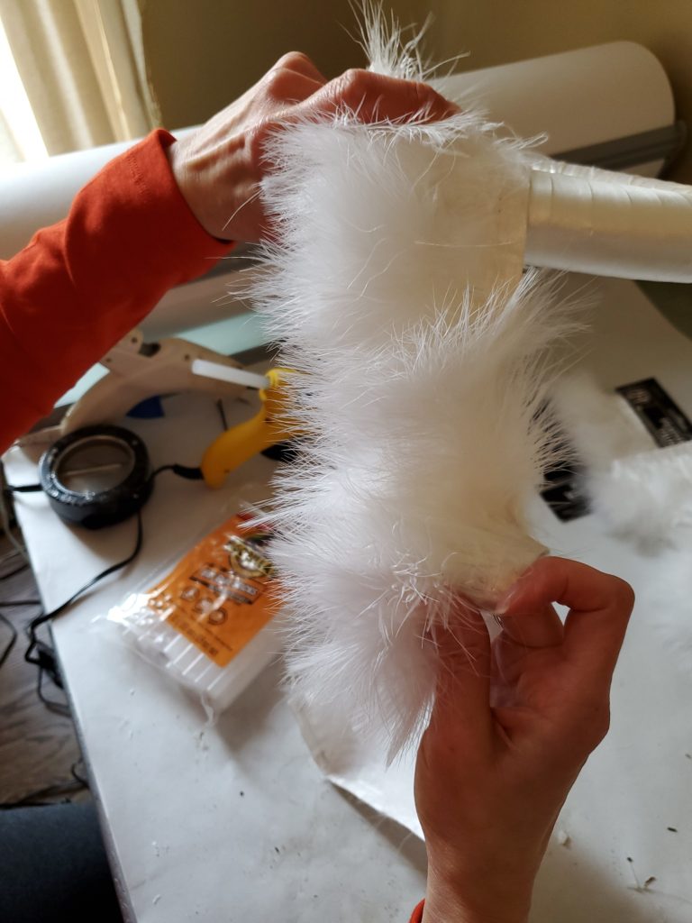 Wrapping the fur trim with satin over the wreath