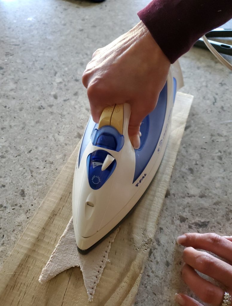 Ironing the banner to make flat