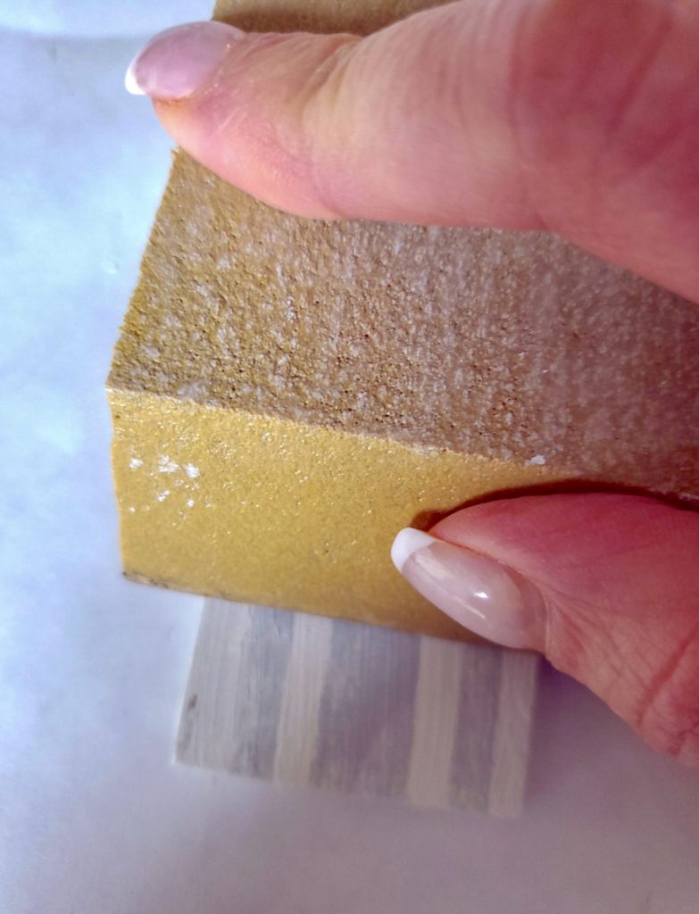 Sanding the stencil with a sanding sponge