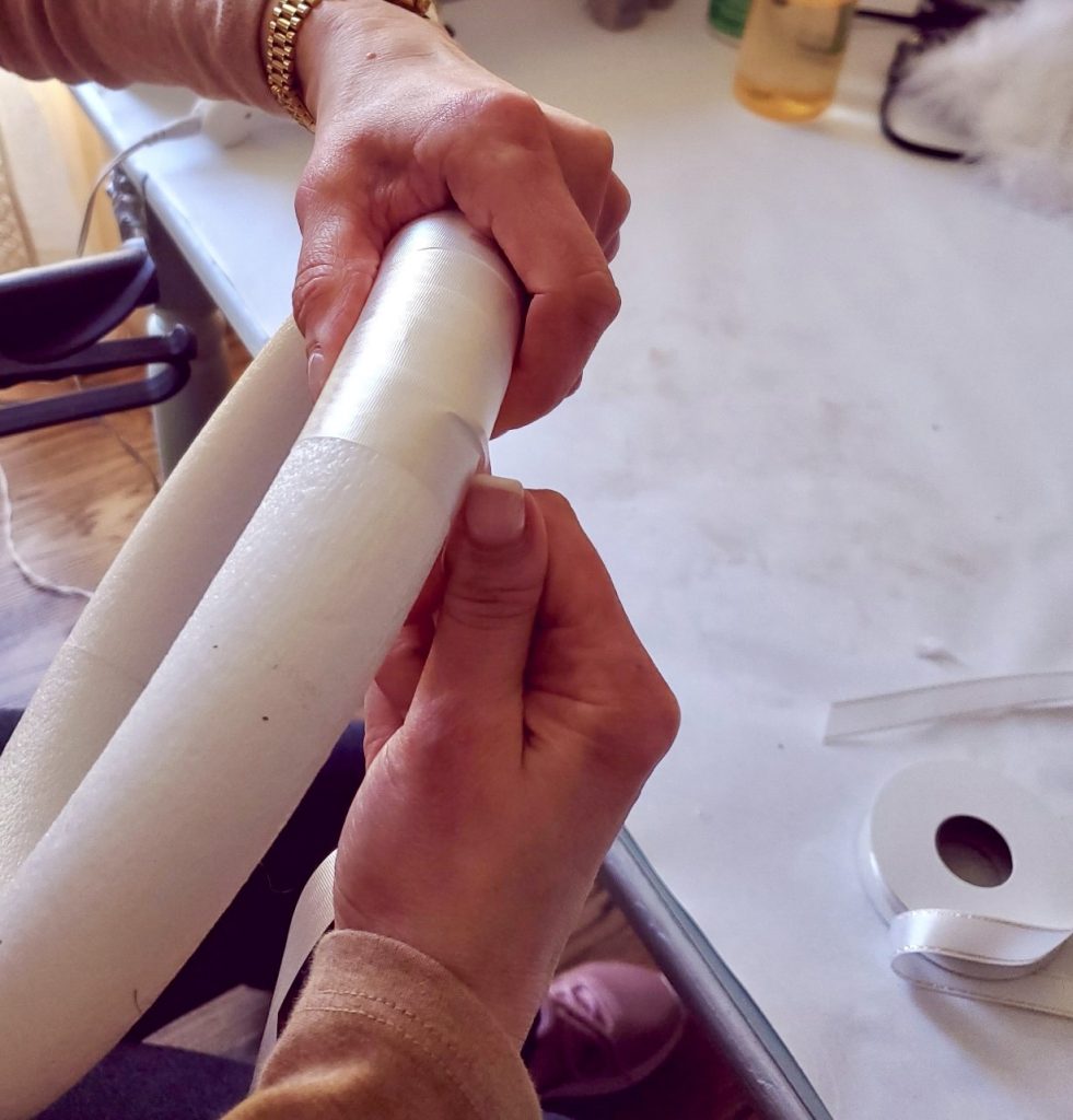 Beginning to wrap the ribbon around the wreath form