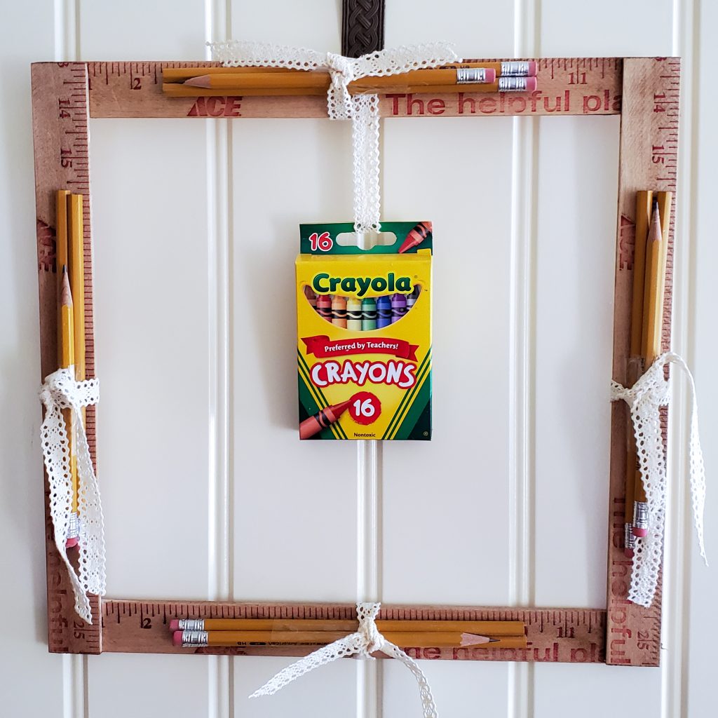closer vew of the back to school wreath.  showing the yard sticks, pencils nd crayons