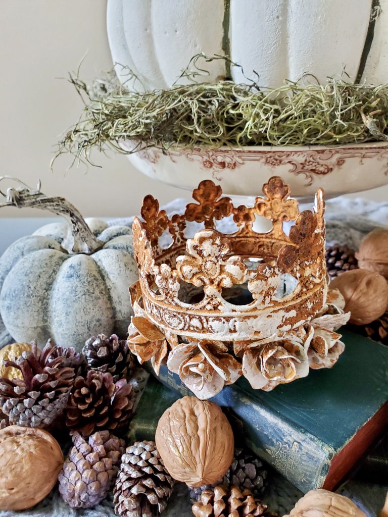close up of the crowns, book and walnuts and pinecones and rust crown