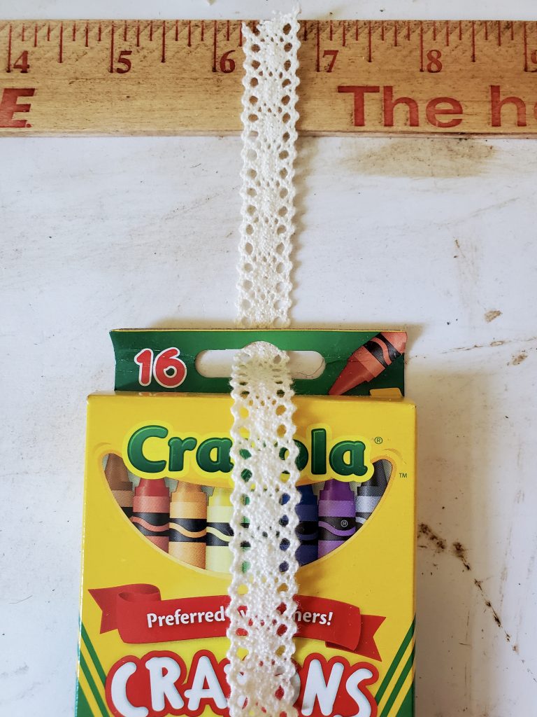 ribbon getting added to the crayon pack for the back to school wreath