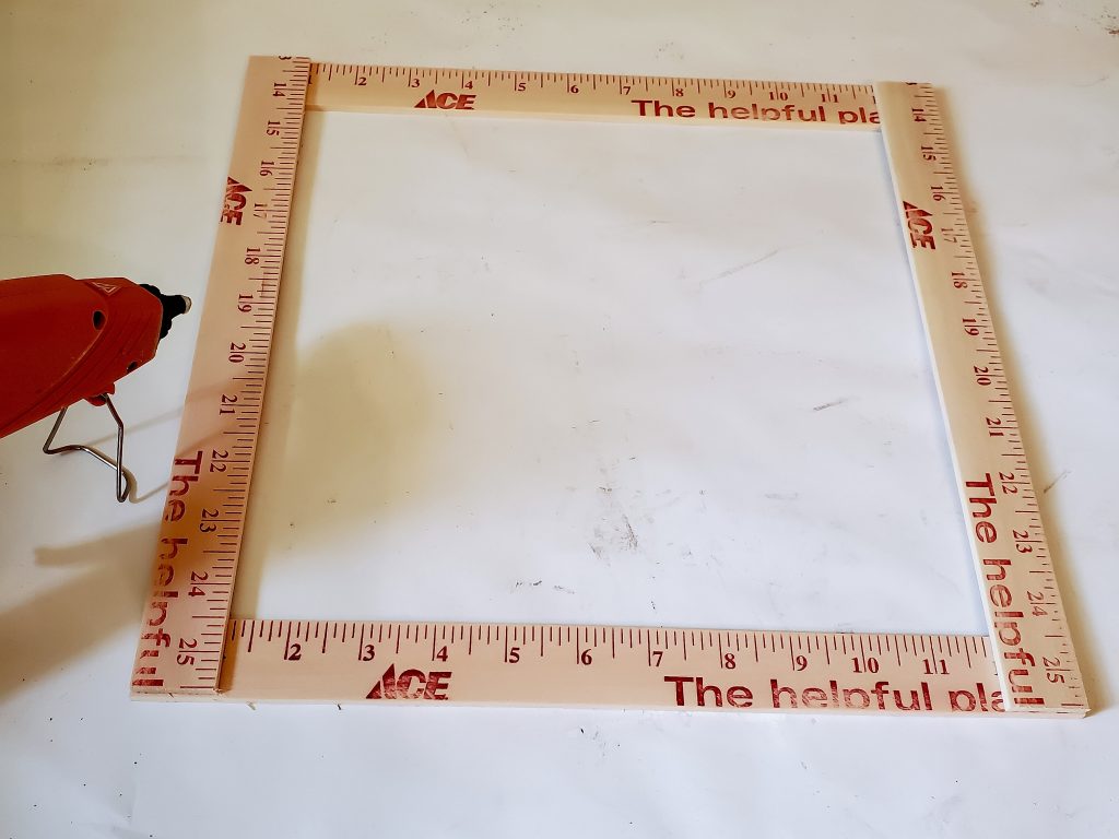 The yard sticks cut to size with glue gun heating 