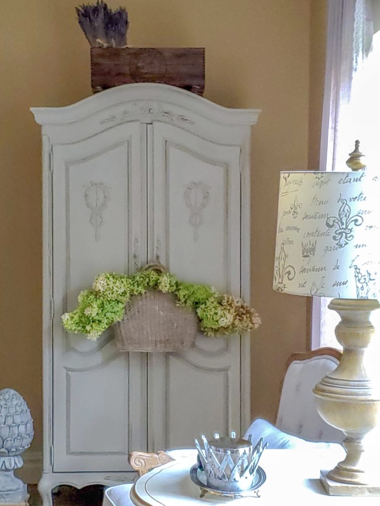 Armoire with hydrangeas in a hanging basket