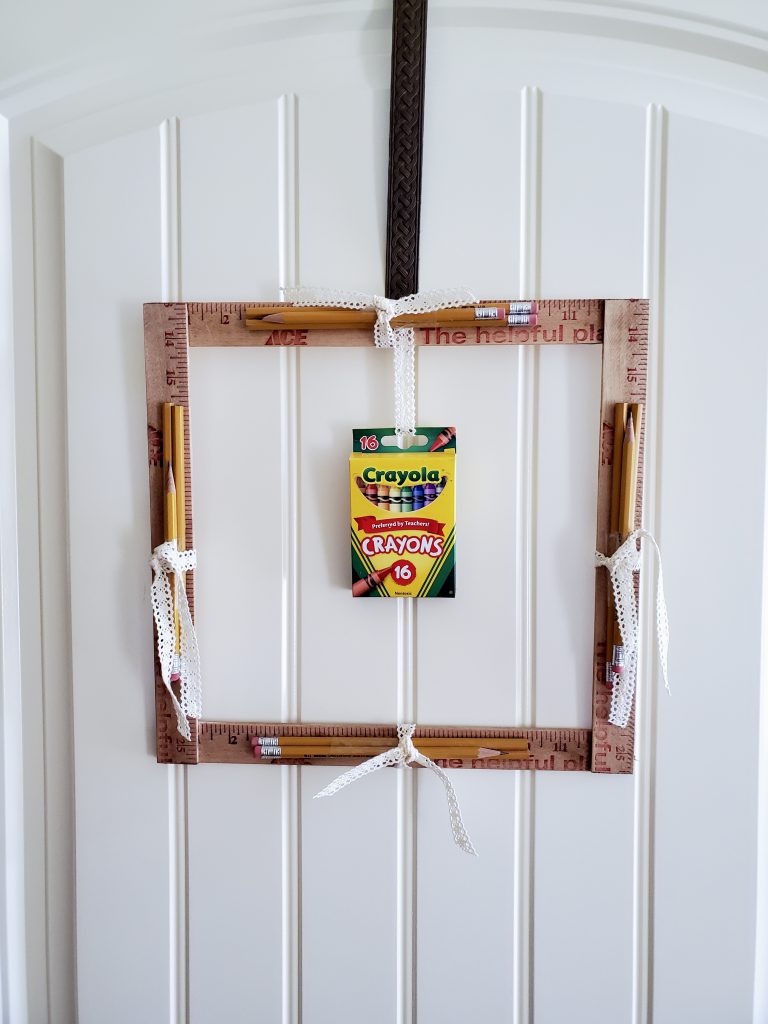 back to school wreath hanging on the door.  showing a close up of the pencils and crayons