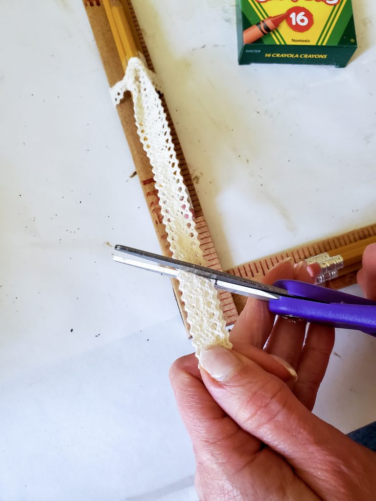 trimming the ribbon to the correctlength hanging from the pencils