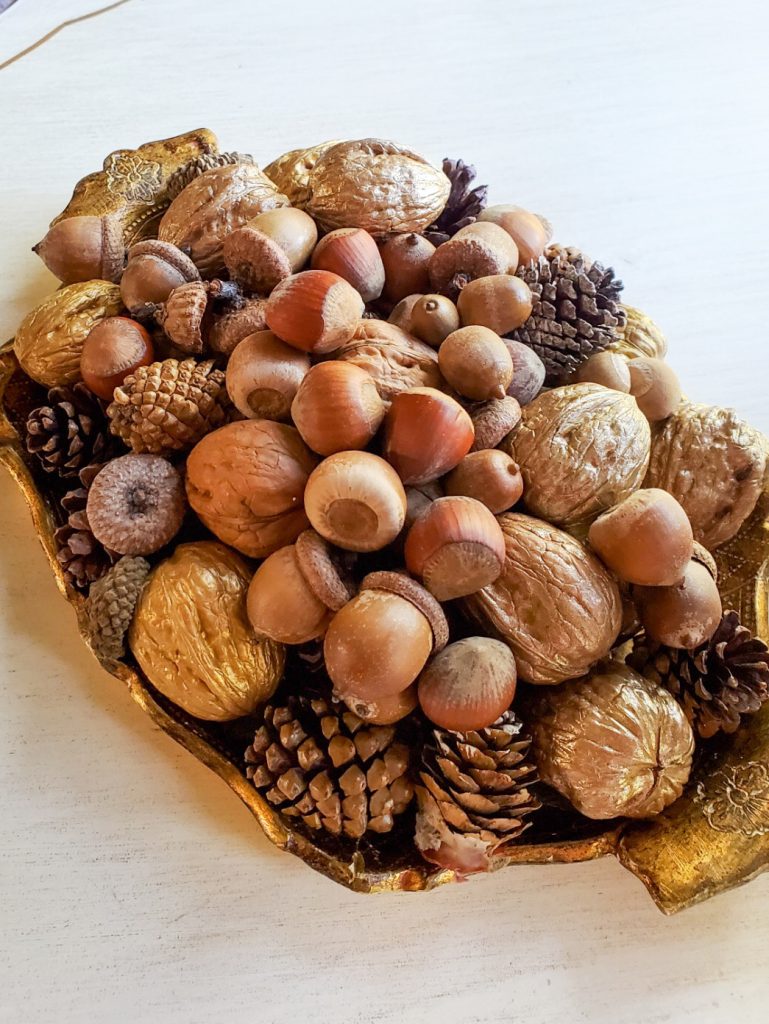A Florentine tray filled with nuts for fall decor