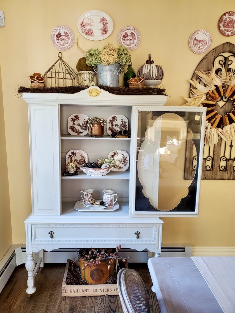 The hutch open with natural decor.