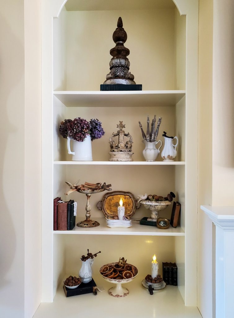 Closer view bookcase with lit candles