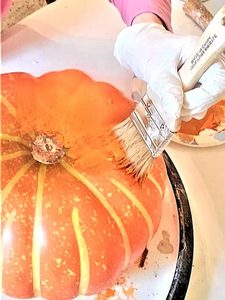 chalk-paint-on-pumpkins-is-a-sustainable-choice-painting-dark-orange