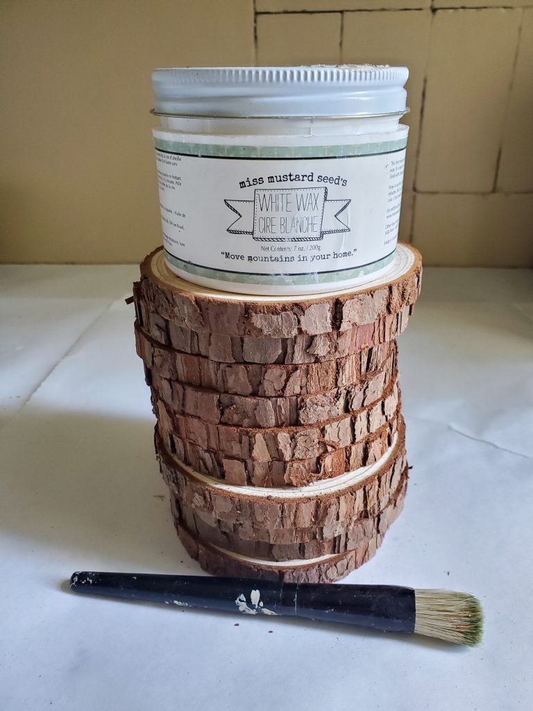 The wood rounds for my DIY wood coasters.  White wax and stencil brush
