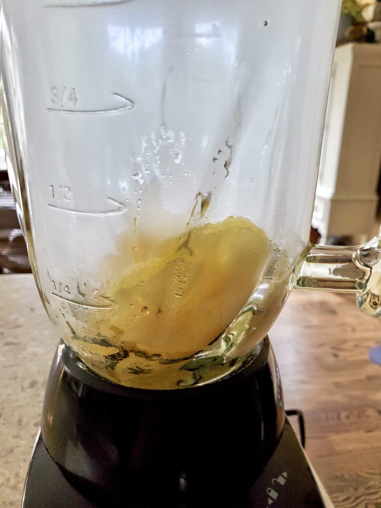 adding the cooked apples to the blender to puree on high