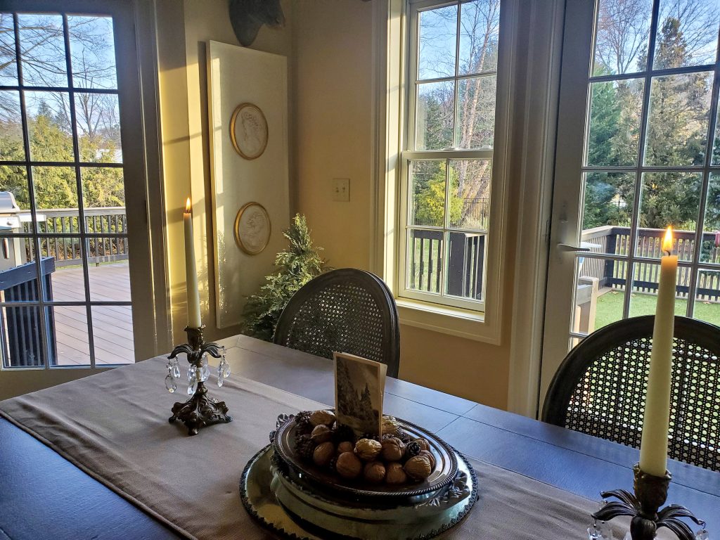 a closeup of the kitchen table with candles lit for a vintage French Christmas