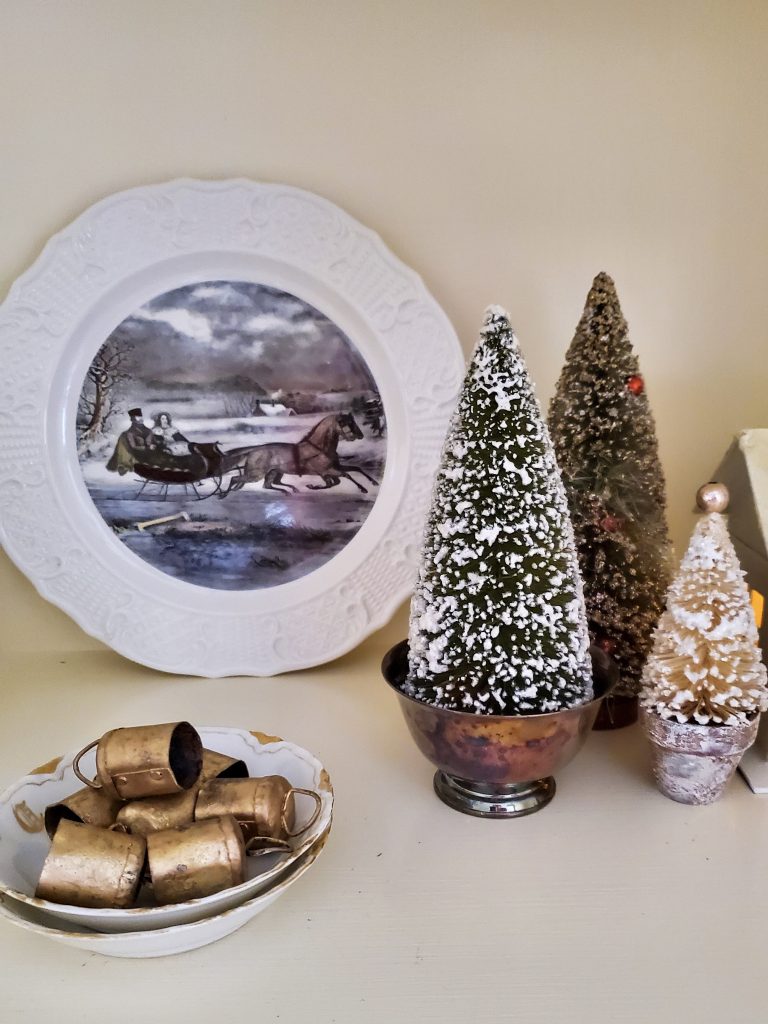 closer look at the bells and dish on the bookcase for a vintage French Christmas