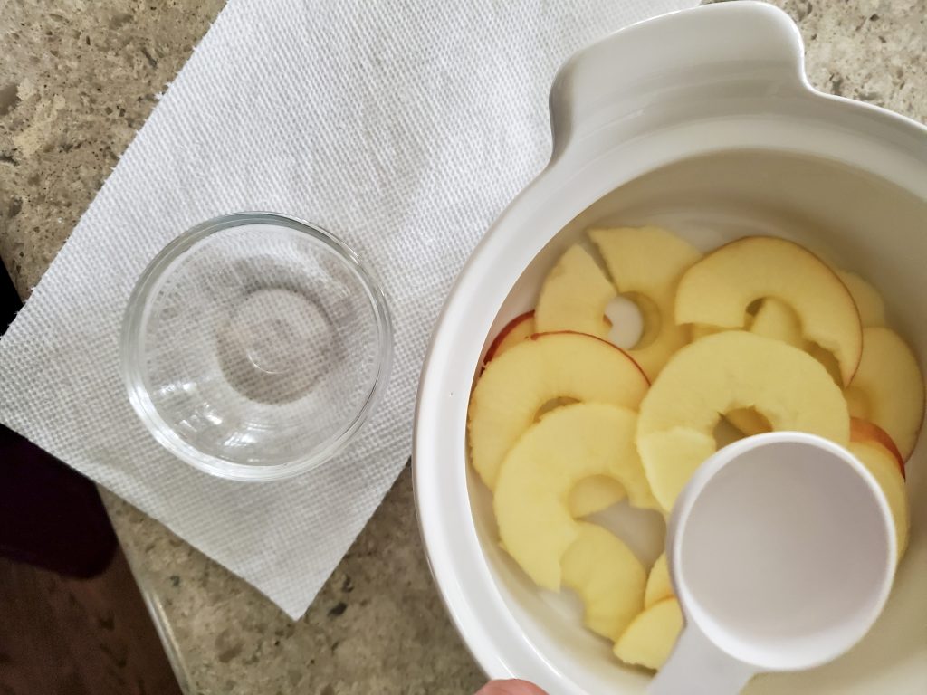 water being added to the sliced apples before it goes in the microwave
