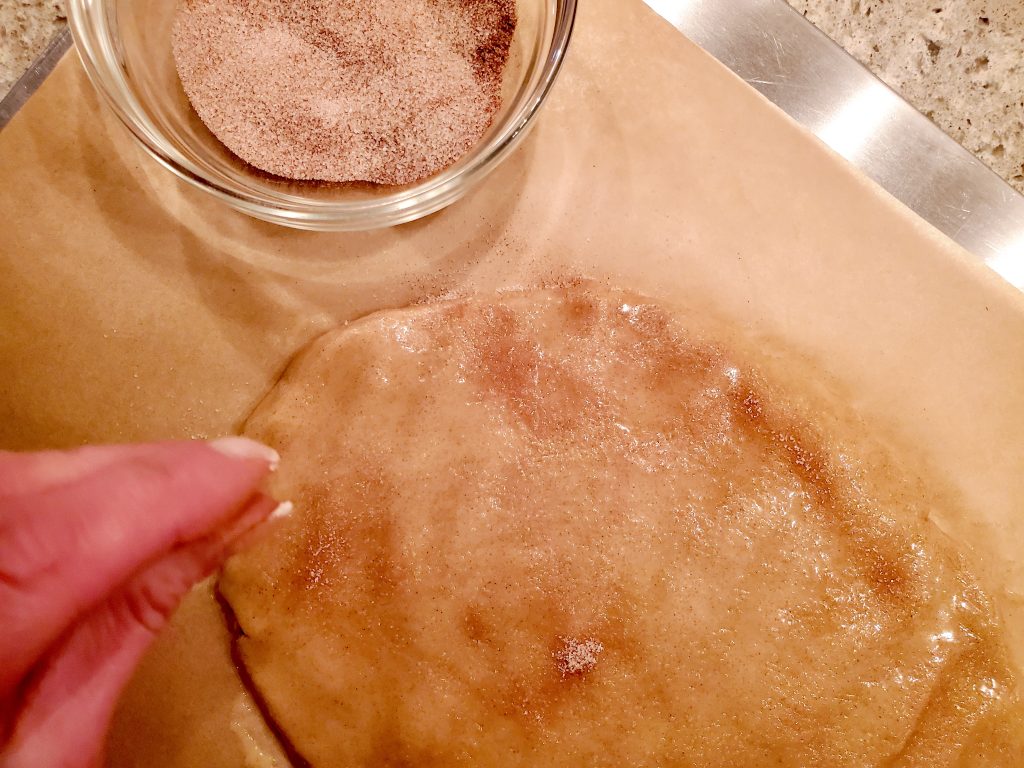 sprinkling the biscotti batter with cinnamon sugar