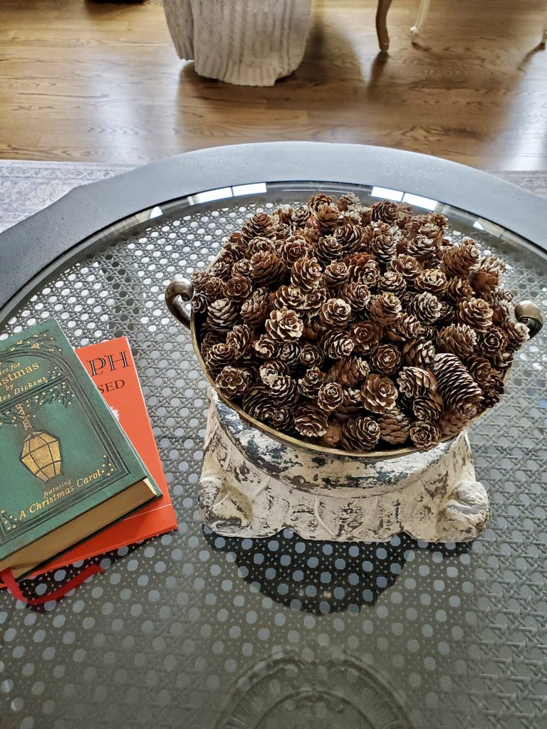 Pinecones in a silver bowl on a coffee tabel in a vintage French Christmas
