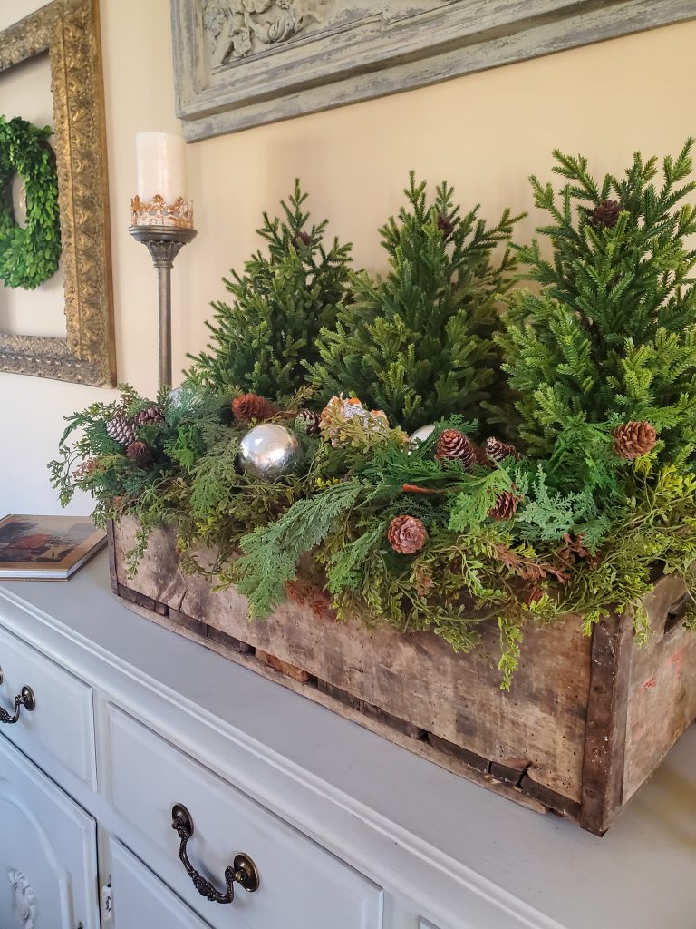an weood crate filled with various greens