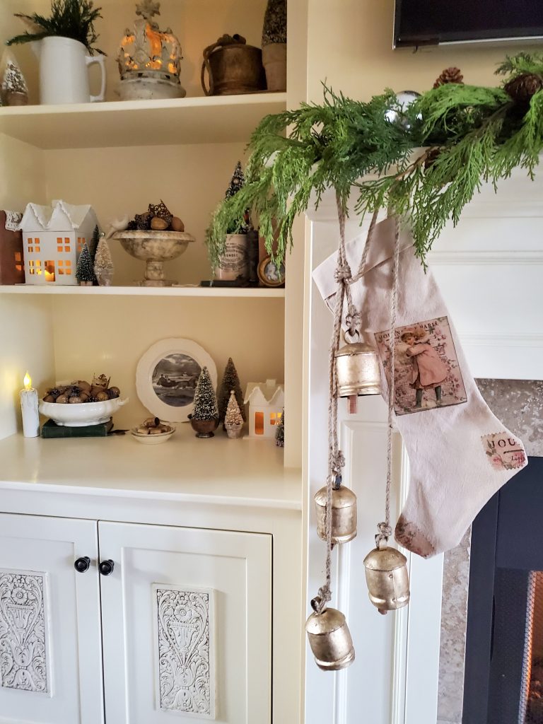 a look t the bells hanging by one stocking and the bookcase in vintage French Christmas