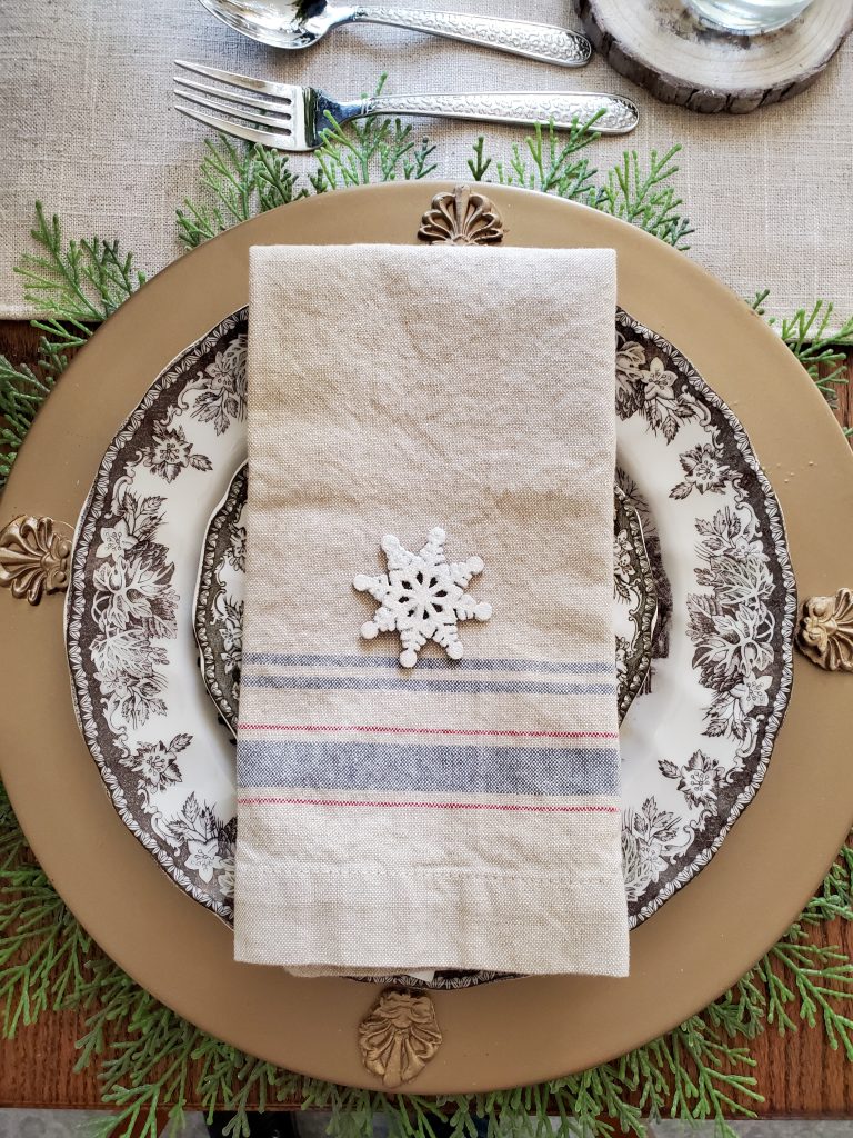 showing a napkin with a glitter snowflake on top for christmas time in the dining room